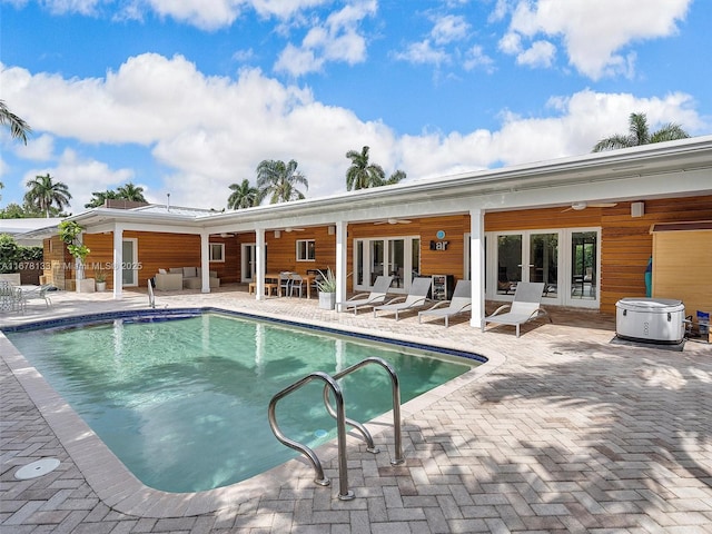 outdoor pool featuring a patio area, french doors, outdoor lounge area, and ceiling fan