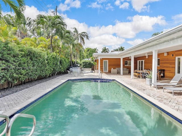 view of pool with a patio area, a fenced in pool, and a fenced backyard