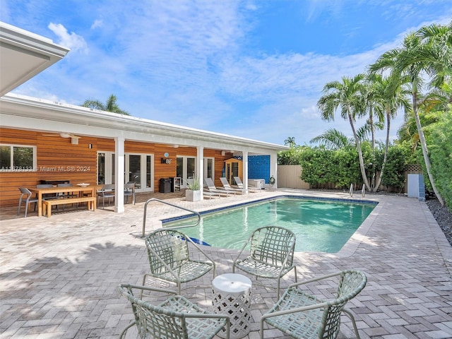 view of pool with a patio and ceiling fan