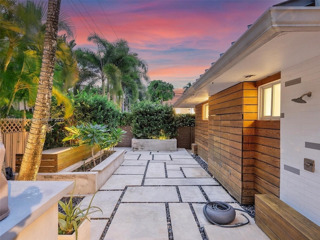 view of patio / terrace featuring fence and a garden