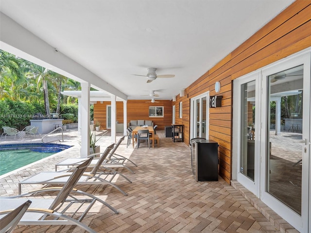 view of patio / terrace featuring an outdoor pool, outdoor lounge area, french doors, and a ceiling fan