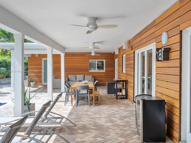 sunroom / solarium featuring ceiling fan