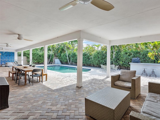 view of swimming pool featuring a patio area and ceiling fan