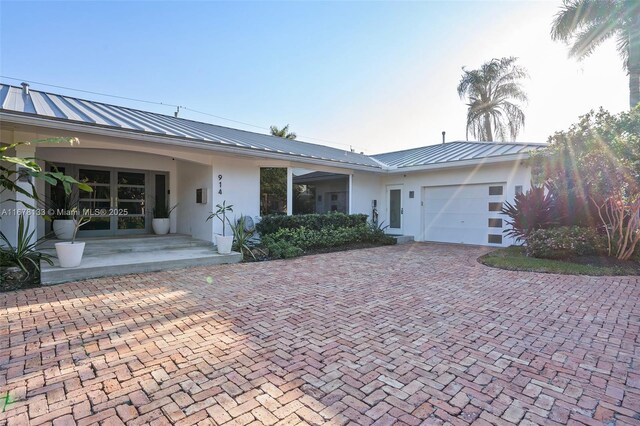 view of front of property with a porch and a garage