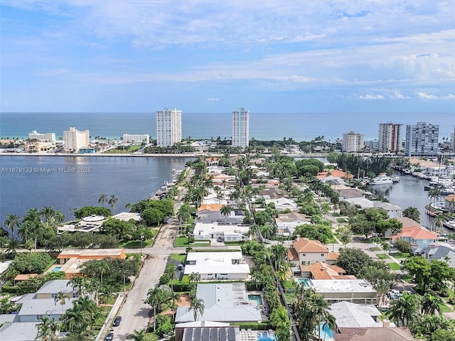 birds eye view of property with a view of city and a water view