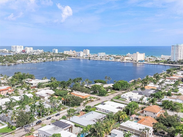 birds eye view of property featuring a view of city and a water view