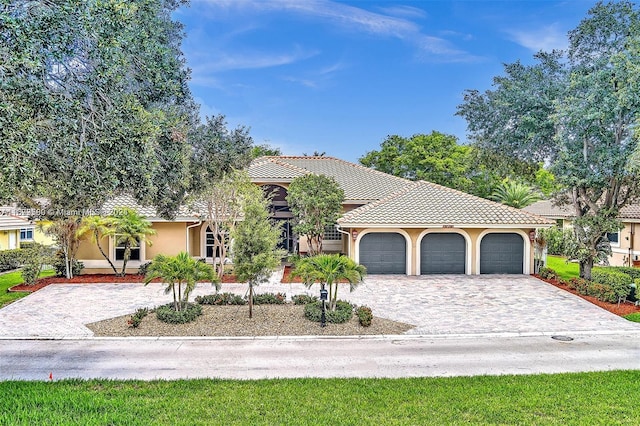 mediterranean / spanish-style home with a garage