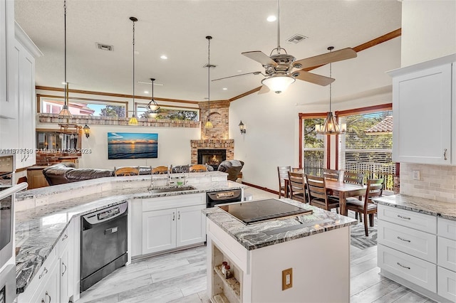 1775 W Eagle Trace Blvd W, Coral Springs, FL 33071 - kitchen featuring a fireplace, a sink, visible vents, and ceiling fan with notable chandelier