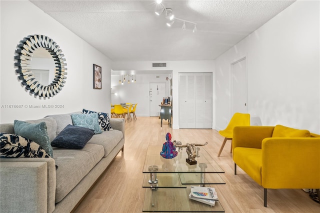 living room with hardwood / wood-style floors and a textured ceiling