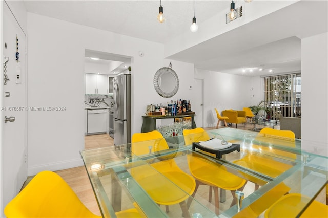 dining area featuring light wood-type flooring