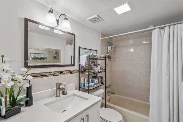 full bathroom featuring vanity, toilet, and shower / bath combo with shower curtain