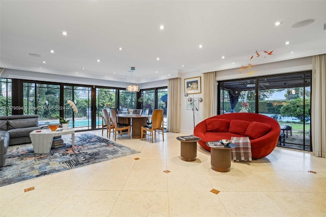 tiled living room with ornamental molding and a wealth of natural light