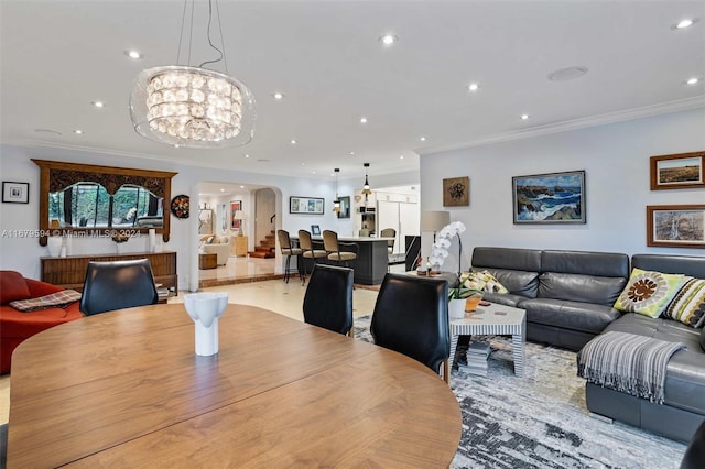 dining area featuring crown molding and a notable chandelier