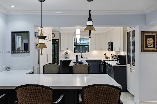 kitchen with stainless steel range, white cabinetry, hanging light fixtures, and ornamental molding