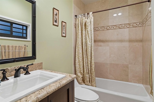 full bathroom featuring vanity, shower / tub combo with curtain, and toilet