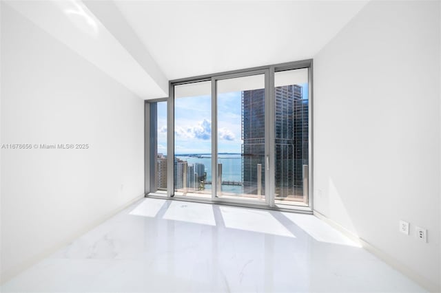 empty room with a water view and floor to ceiling windows