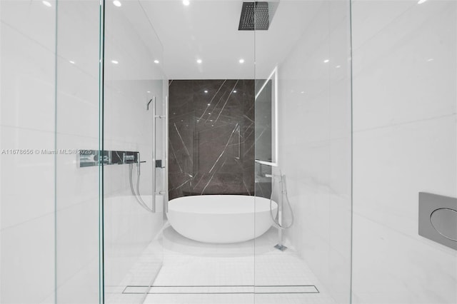 bathroom with plus walk in shower, tile patterned floors, and tile walls