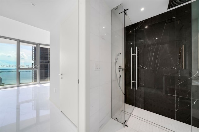 bathroom featuring tiled shower and tile patterned flooring