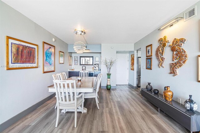 dining room featuring a chandelier and light hardwood / wood-style floors