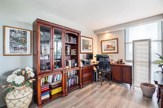 home office with light wood-style flooring