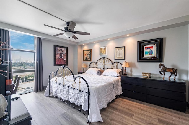 bedroom with access to exterior, recessed lighting, light wood-style flooring, and a ceiling fan