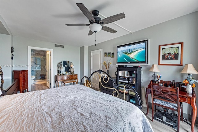 bedroom with ensuite bath, light wood finished floors, ceiling fan, and visible vents