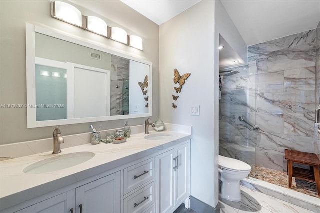 full bathroom with marble finish floor, double vanity, a sink, and a marble finish shower