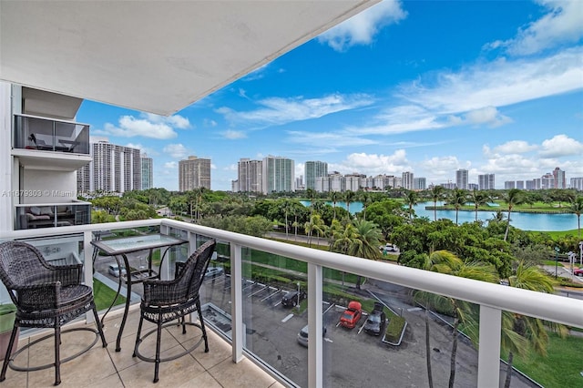 balcony featuring a view of city and a water view