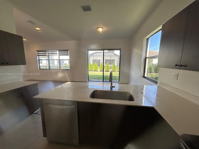 kitchen with visible vents, modern cabinets, light countertops, stainless steel dishwasher, and a sink