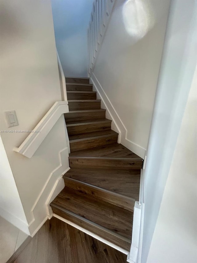 stairs featuring wood finished floors