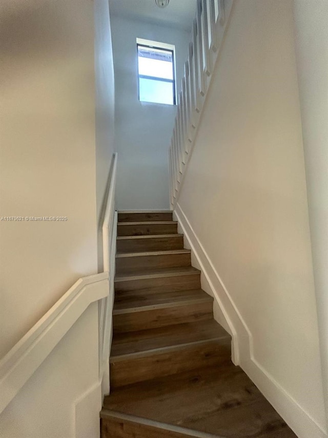 stairs with wood finished floors