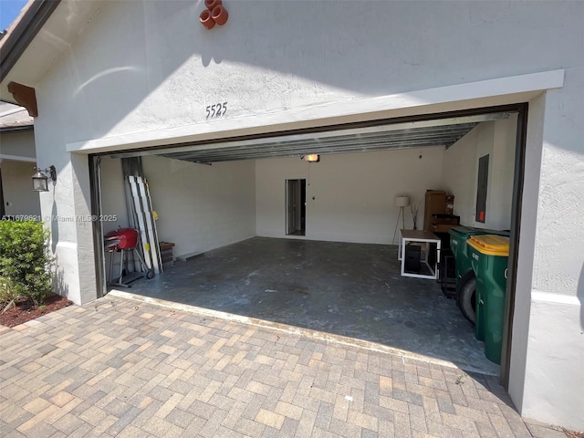 garage featuring decorative driveway