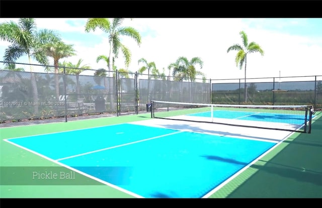 view of sport court featuring fence