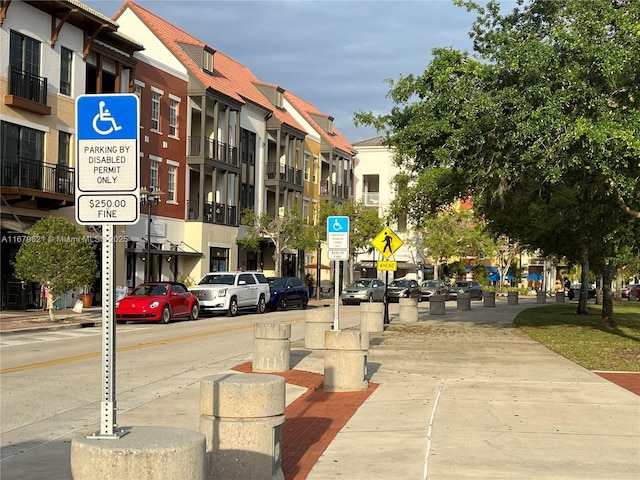 exterior space with curbs, traffic signs, and sidewalks