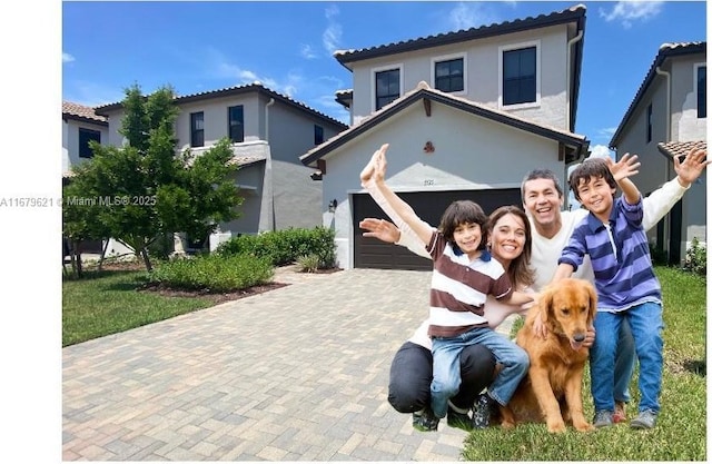 mediterranean / spanish-style home with decorative driveway and a tiled roof