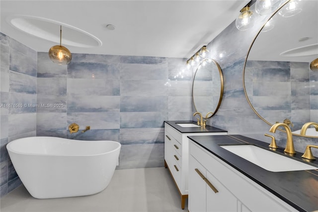 bathroom with a washtub, vanity, and tile walls