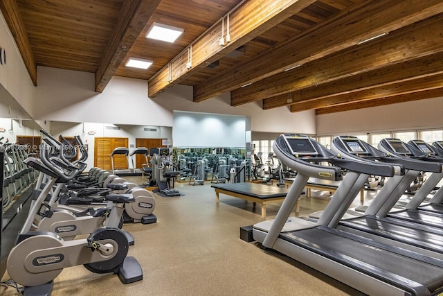 exercise room featuring a high ceiling, a wealth of natural light, and wood ceiling