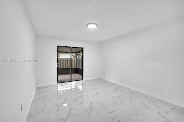 empty room with a textured ceiling