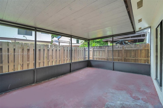 unfurnished sunroom with wooden ceiling