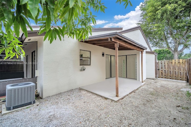 rear view of house with a patio and central air condition unit