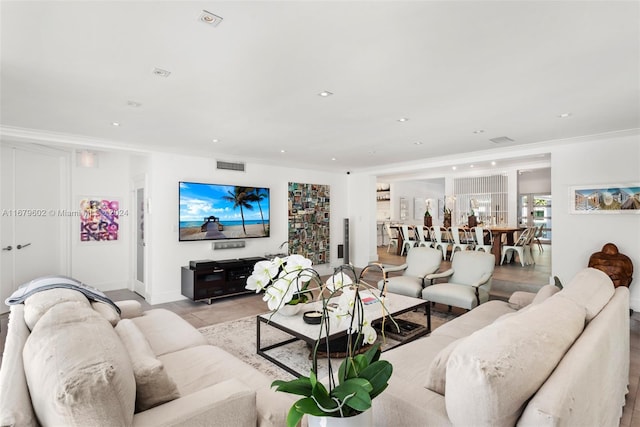 living room with ornamental molding and light tile patterned floors