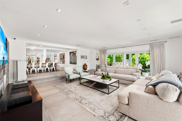 living room featuring ornamental molding and light tile patterned floors