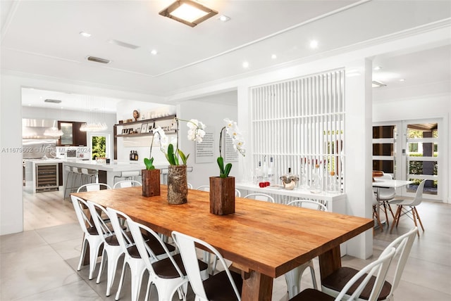 dining area featuring wine cooler and light hardwood / wood-style flooring