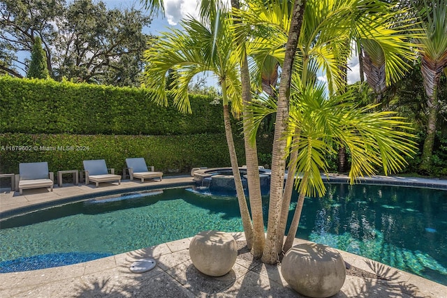 view of pool with an in ground hot tub and a patio area