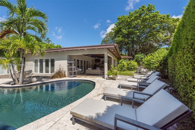 view of pool featuring a patio area, french doors, and outdoor lounge area