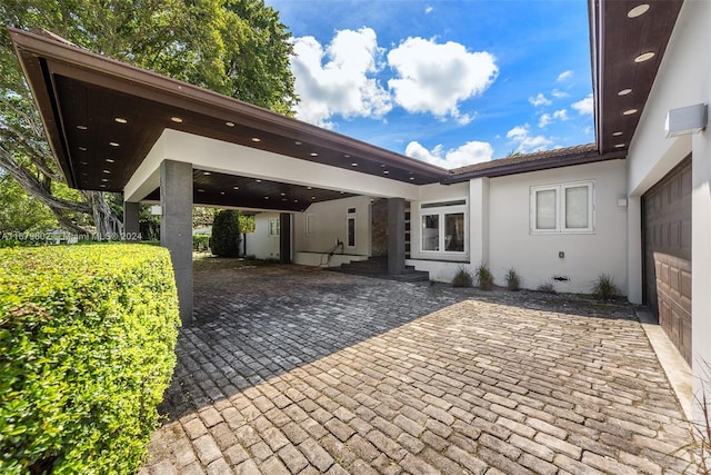 view of patio / terrace featuring a garage and a carport