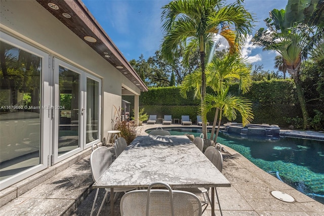 view of patio featuring a pool with hot tub