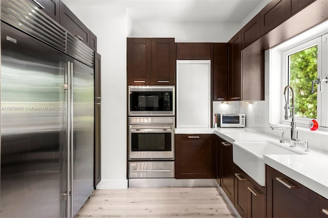 kitchen featuring sink, stainless steel appliances, and light wood-type flooring