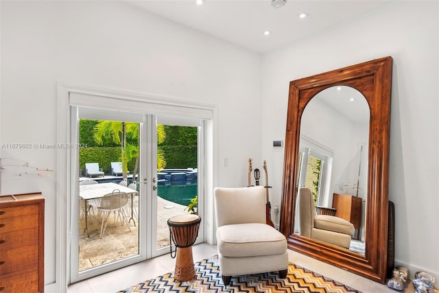 living area with french doors and light tile patterned flooring