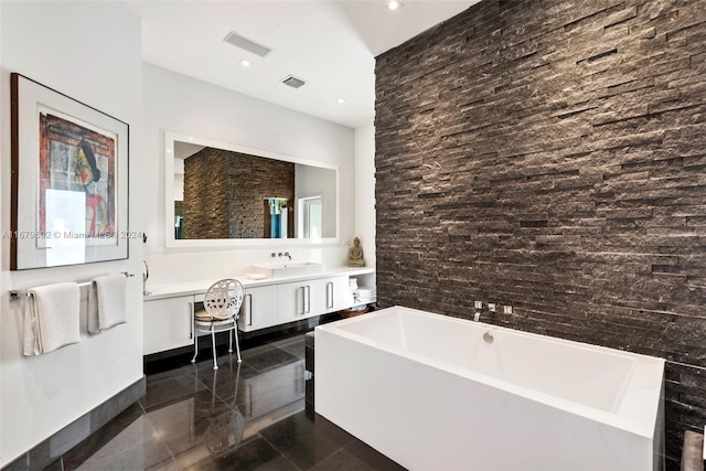 bathroom with vanity and a tub